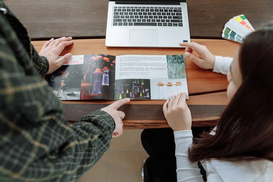 Team members discussing digital graphs on a tablet in a modern office setting.